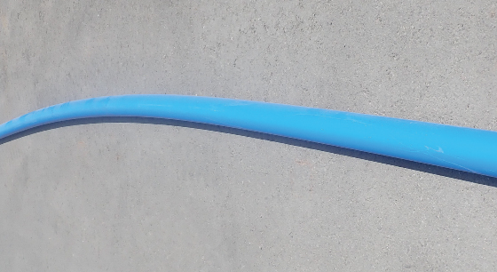 平行な状態で保管しなかった場合の湾曲したポリエチレン管の例